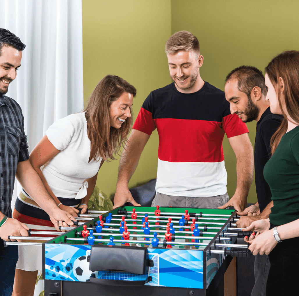 Group playing foosball