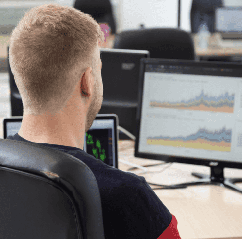 Man looking on his desktop screen with charts
